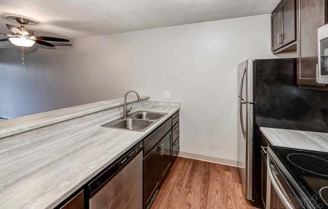a kitchen with a sink and a refrigerator