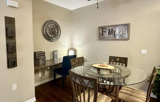 a dining room with a glass table and a ceiling fan