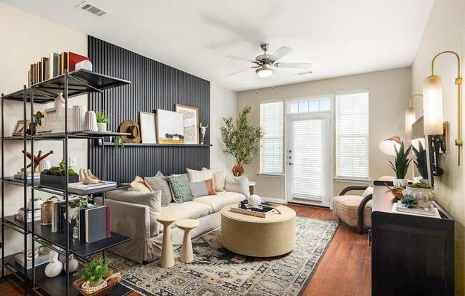 a living room with a white couch and a ceiling fan
