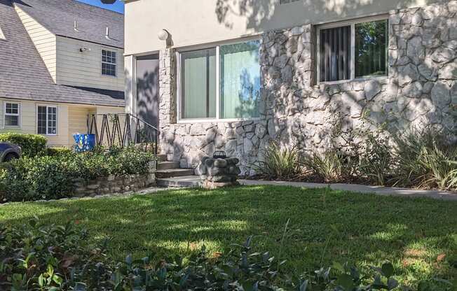 Lush gardens and shaded grass area inside gates of Los Robles Apartments in Pasadena, California.