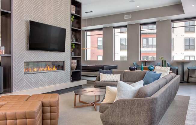 Naturally lit and spacious community space with a fireplace.