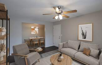 an open living room and dining room with a ceiling fan