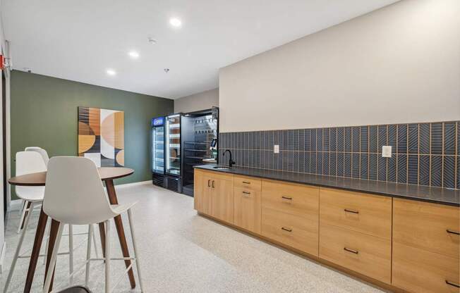 a kitchen with a table and chairs and a refrigerator