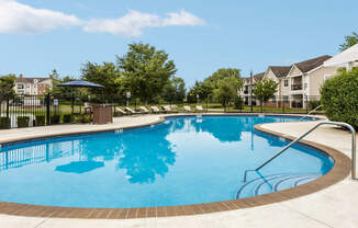 A large swimming pool with a ladder on the side.
