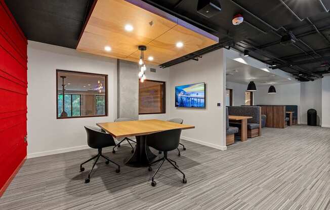 A conference room with a wooden table and chairs.