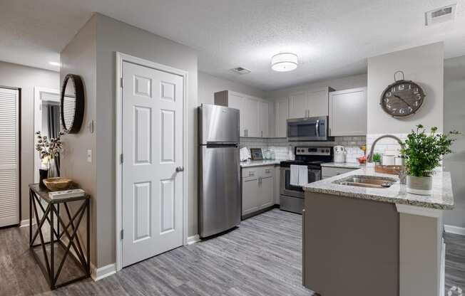our spacious kitchen is equipped with stainless steel appliances and a granite counter top