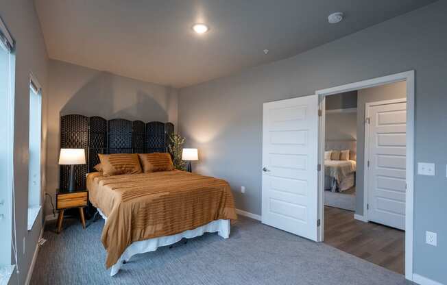 a bedroom with a bed and a door to a bathroom at Technology Park Apartments, Minnesota