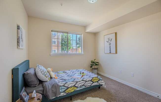 a bedroom with a bed and a couch in front of a window  at Quail Springs, West Richland