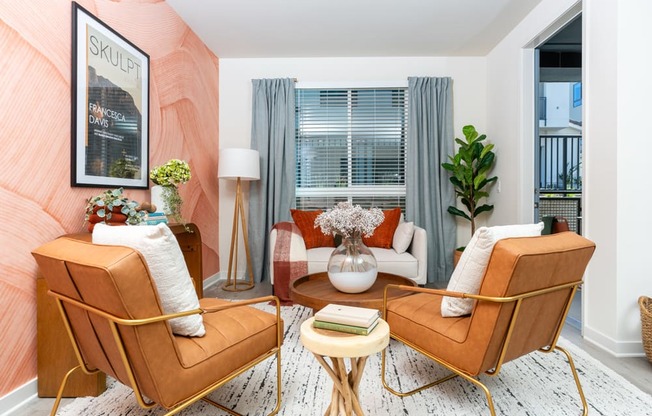 A living room with two chairs and a table.