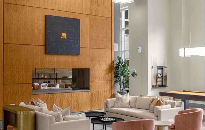 a living room with couches and chairs and a fireplace