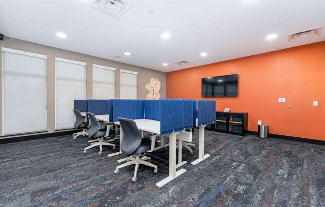 A conference room with blue dividers and chairs.