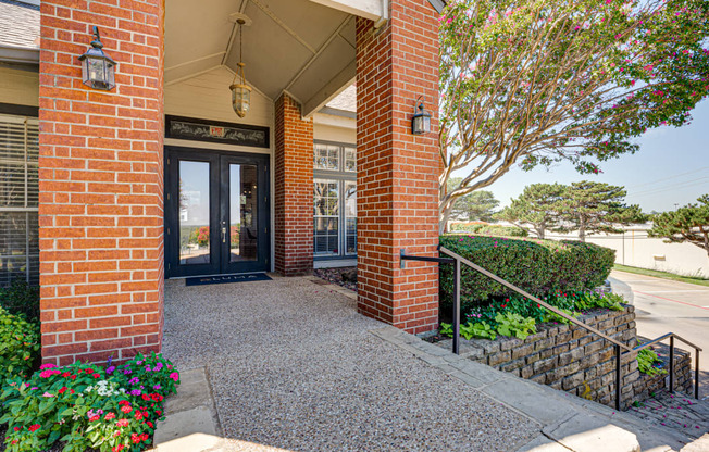 the entrance to a brick building with a glass door