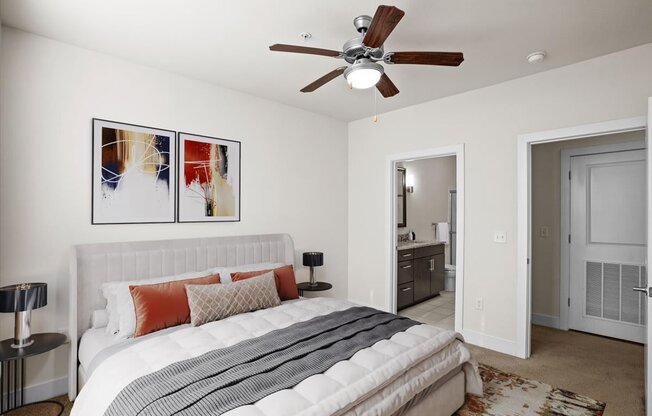 a bedroom with a bed and a ceiling fan