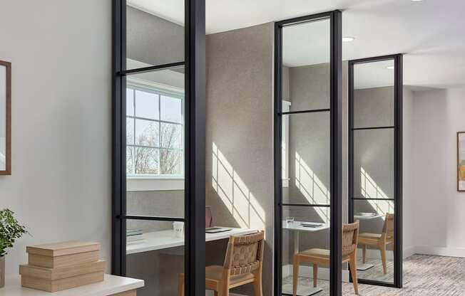 A room with a desk, chair, and a large mirror.