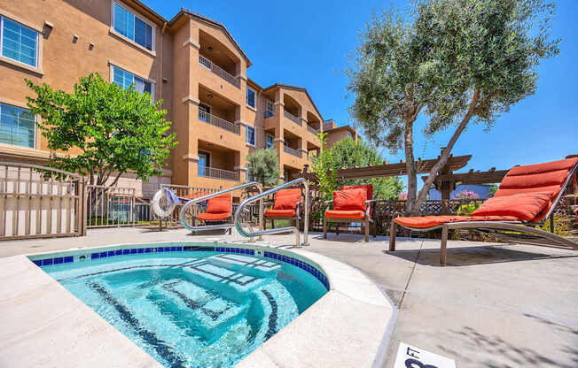 our apartments have a resort style pool with lounge chairs and trees
