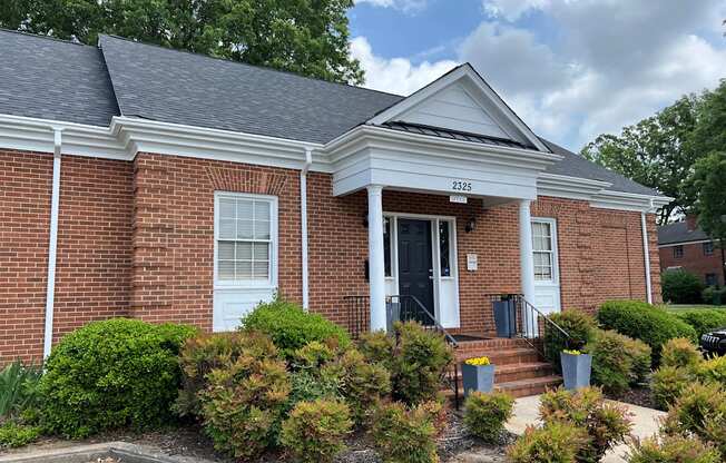 a brick building with a black door and white trim