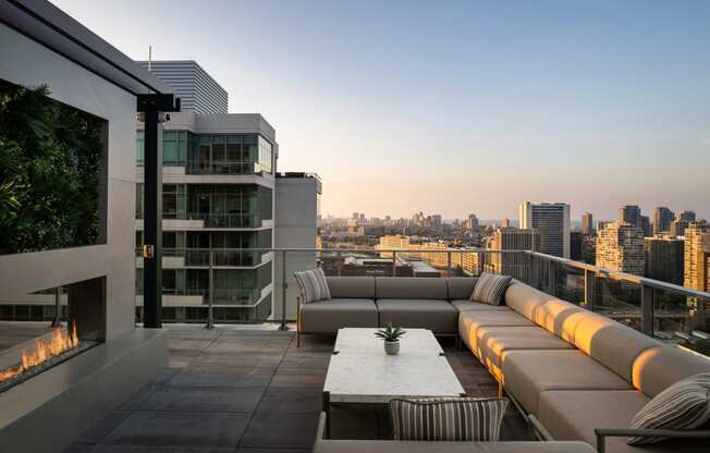 a terrace with couches and a table with a potted plant