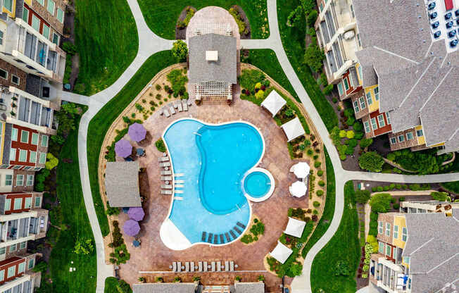 An aerial view of a swimming pool surrounded by buildings.