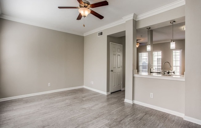 Apartments in Houston - The Maroneal Open Layout Living Room With Hardwood Style Flooring Ceiling Fan and Modern Finishes