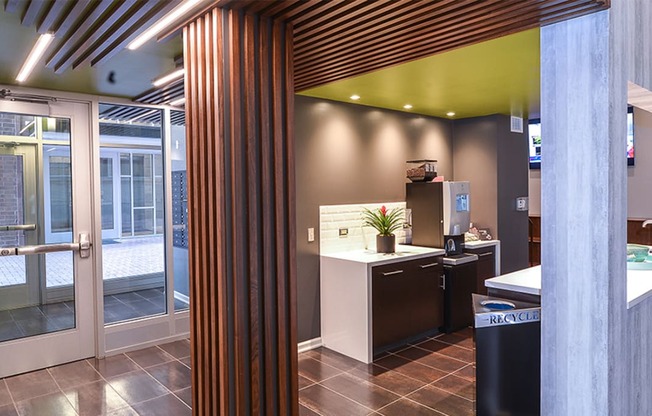 a view from the kitchen into the reception area with a wood column in the foreground