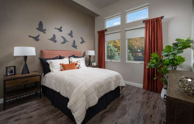 a bedroom with a bed and birds on the wall