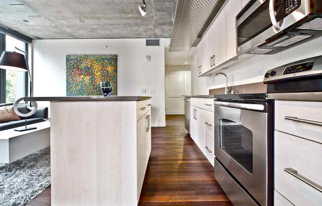 a kitchen with white cabinets and stainless steel appliances