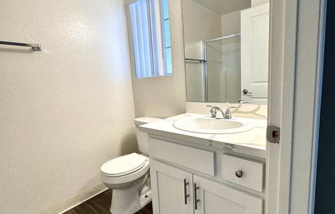 a bathroom with a toilet sink and mirror