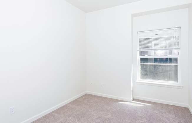A room with a window and carpeted floor at The Landing Apartments and Townhomes, Oregon, 97045