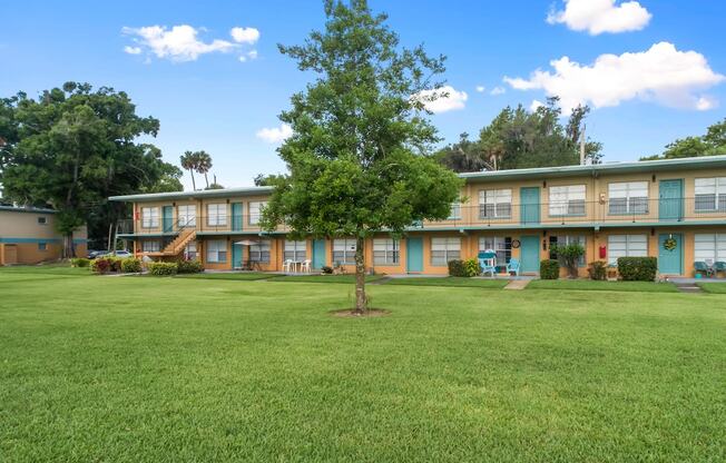 Park Apartments features a large grassy courtyard with trees throughout