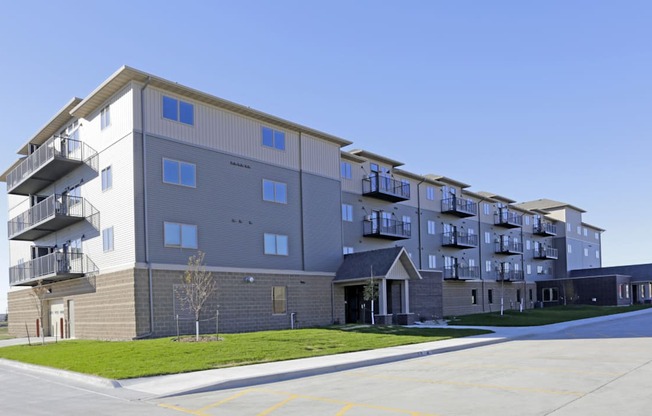 Apartment building with a parking lot in front. Fargo, ND 29 West Apartments