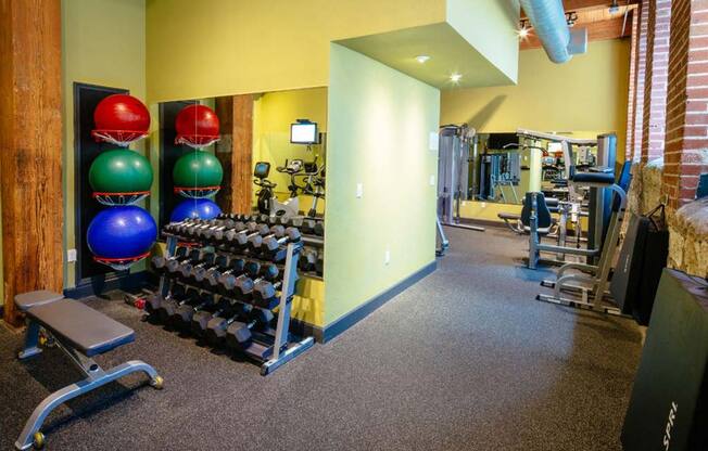 Lofts at Lafayette Square fitness center with free weights and medicine balls.