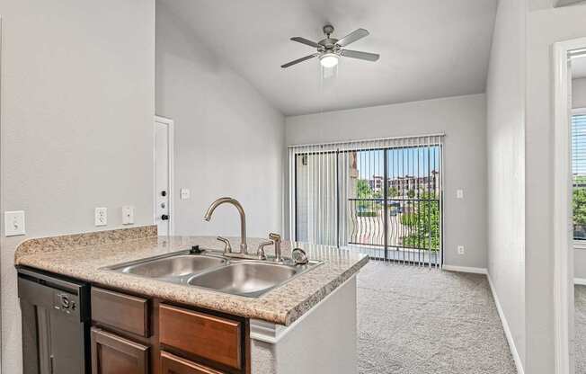 A kitchen with a sink and a fan.