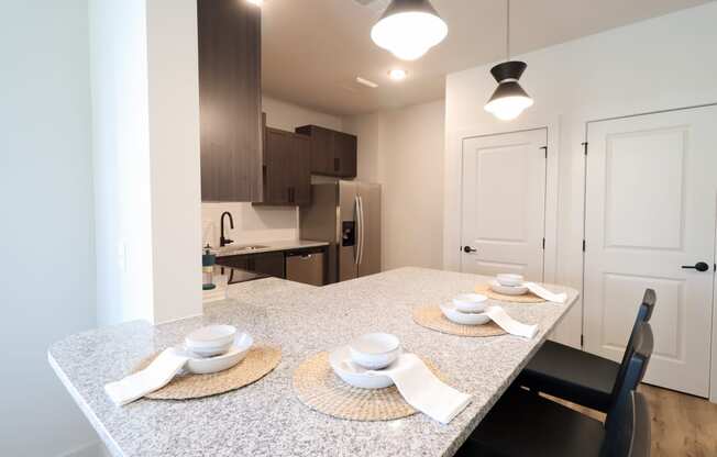 The Crest at South Point Apartments B3 Model Apartment Kitchen with Barstool Seating located in McDonough, GA