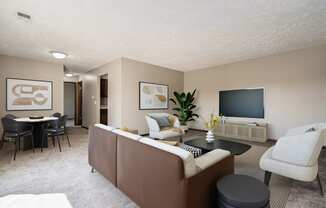 Omaha, NE Maple Ridge Apartments. A living room filled with furniture and a flat screen tv