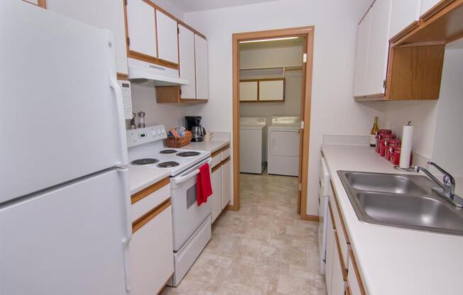 Galley style kitchen with attached laundry at The Northbrook Apartments in Lincoln NE