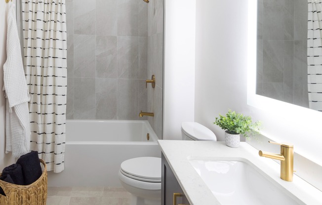 Serene bathroom featuring an LED backlit mirror and premium fixtures
