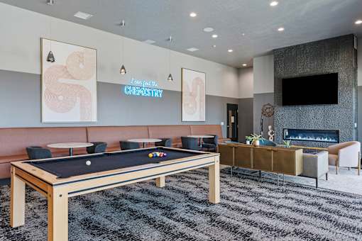 a game room with a pool table and a television at SevenO2 Main Apartments, Salt Lake City, UT, 84101