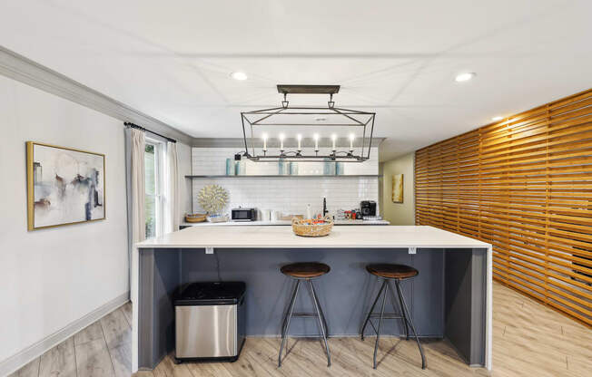 a kitchen with a counter top and three stools