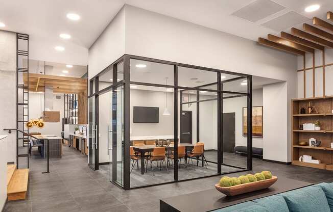 a conference room with glass walls and a table and chairs