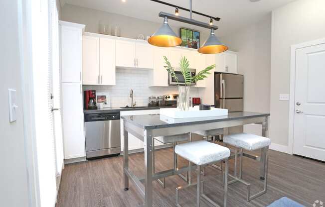 a kitchen with stainless steel appliances and a counter with stools at Century Baxter Avenue, Kentucky, 40204