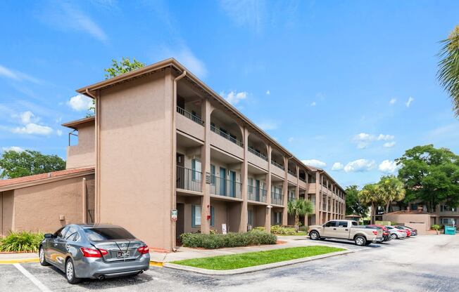 an apartment building with cars parked in front of it