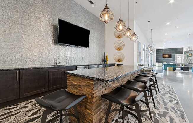A modern table with a stone counter and black stools.
