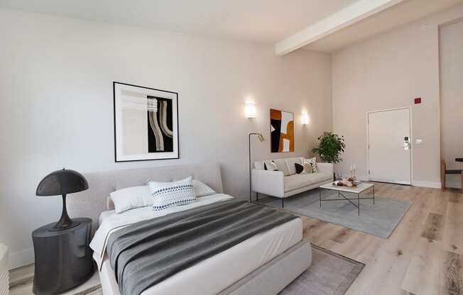 a bedroom with a bed and a couch and a living room at Track 281 Apartments, Sacramento, CA