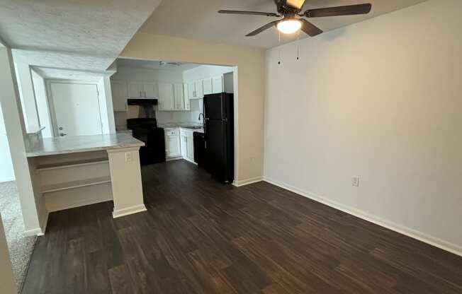 a living room with a wooden ceiling and a ceiling fan