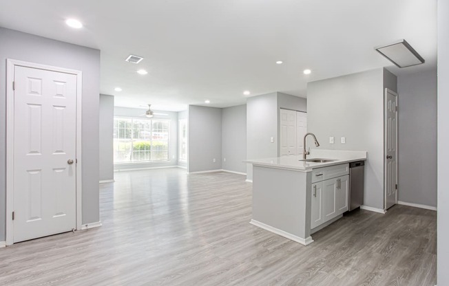 an empty kitchen and living room with a door to a window at Parc at 1875, Georgia