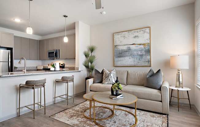 a living room and kitchen with a couch and a table