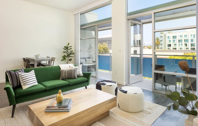 a living room with a green couch and a wooden coffee table