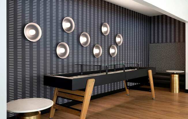 A black and white room with a long table and chairs.