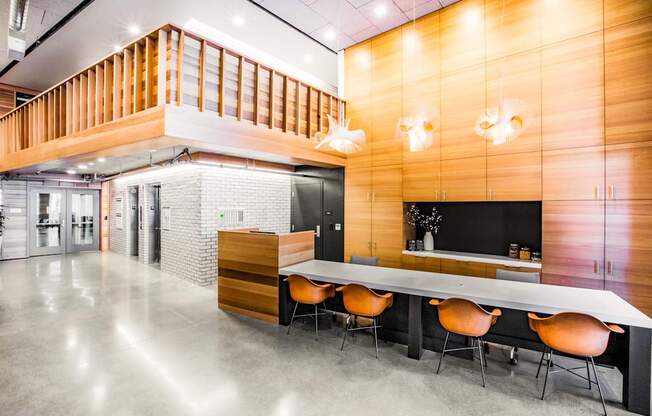 A modern office space with a long table and chairs.