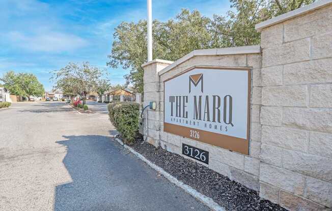The Marq Apartment Homes sign is on a stone wall at The Marq apartments in Shreveport, LA